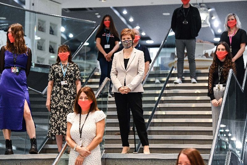 Scotland's First Minister, Nicola Sturgeon wears a Tartan face mask as she visits New Look at Ford Kinaird Retail Park in Edinburgh . (Photo by Jeff J. Mitchell/Pool via AFP Photo)